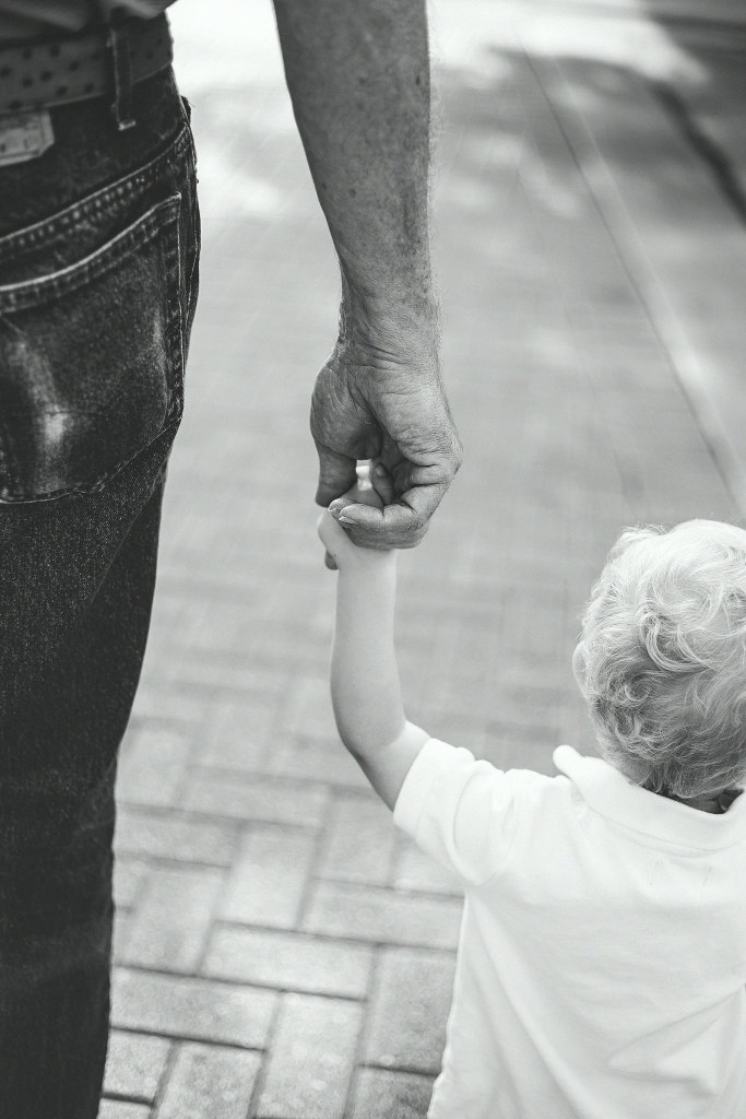 Father holding the hand of a child